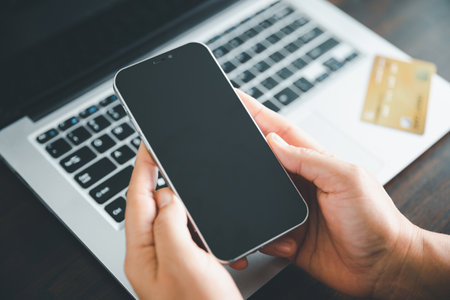 Woman hands of using online virtual app on mobile phone. Millennial guy chatting on smartphone, using banking services, reading text message, typing, shopping, making call, browsing internet.Close upの写真素材
