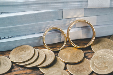 Save money and planning wedding concept. Sustainable financial goal for family life or married life. Rings with stack of coins, saving money for marry, depicts savings or growth for new family.の写真素材