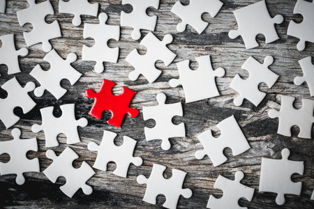 White details of jigsaw puzzle piece on wooden background. Concept of working together as a business...