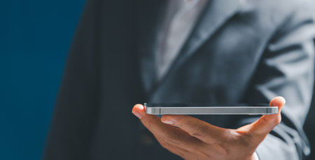 Businesswoman hand holding tablit or smartphone with virtual screen, modern background concept, can put your text with icon bundle, copy spaceの写真素材