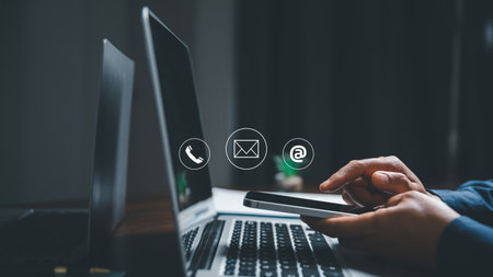 Customer support hotline contact us people connection concept. Web page online customer service technology idea. Businesswoman using smartphone with email, call phone, address, Chat message icons.の写真素材