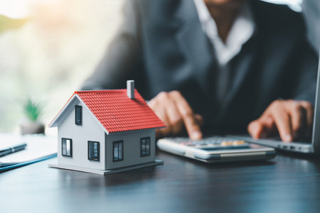 Business woman or lawyer accountant working financial investment on office. insurance protective hand over house for protection and care, Concept of home and real estate Property insurance.の写真素材