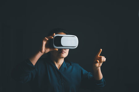 Woman with glasses of virtual reality. Future technology concept. Metaverse technology concept. VR virtual reality goggles. Futuristic lifestyle. female using virtual reality headset at home office.の写真素材