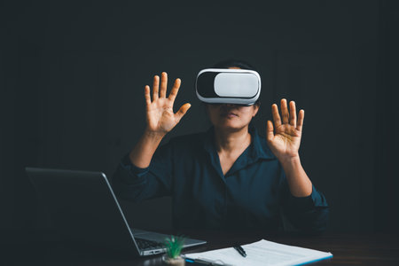 Woman with glasses of virtual reality. Future technology concept. Metaverse technology concept. VR virtual reality goggles. Futuristic lifestyle. female using virtual reality headset at home office.の写真素材