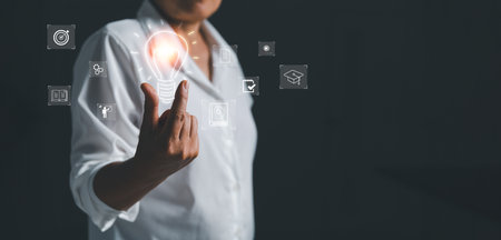 Female holding lightbulb showing graduation hat, Internet education course degree, study knowledge to creative thinking idea and solving solution. E-learning graduate certificate program concept.の写真素材