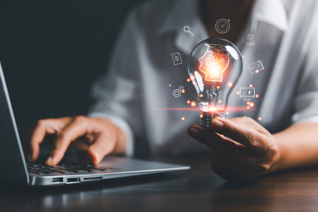 Female holding lightbulb showing graduation hat, Internet education course degree, study knowledge to creative thinking idea and solving solution. E-learning graduate certificate program concept.の写真素材