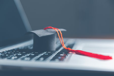 Graduation cap on laptop computer. Concept of global business study, abroad educational, Back to School. Education in Global world, Study abroad business in universities in worldwide. language studyの写真素材