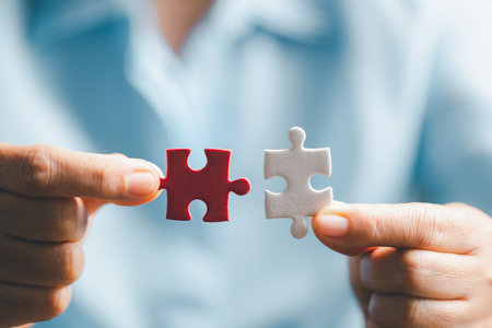 Business woman person hand holding puzzle piece idea for strategy and solution. Closeup part of two jigsaw connect together. Concept of join cooperation success teamwork-problem corporate teamの写真素材