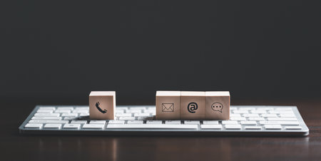 Website page contact us or e-mail marketing concept, Customer support hotline Contact us people connection. cube wood with email, call phone, address, Chat message icons. banner with copy space.の写真素材