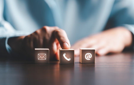 Website page contact us or e-mail marketing concept, Customer support hotline Contact us people connection. cube wood with email, call phone, address, Chat message icons. banner with copy space.の写真素材