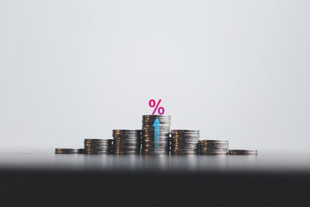 Stacked coins on wooden table with illustration shows increasing of interest rates, financial...