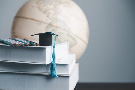 Graduation cap with Earth globe. Concept of global business study, abroad educational, Back to School. Education in Global world, Study abroad business in universities in worldwide. language studyの写真素材