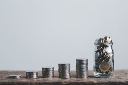 Coins in glass jar for money saving financial concept. Saving money wealth and financial concept,...