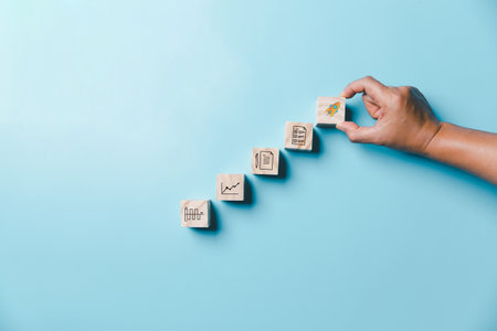 Success and necessary skills in graduation or education. Knowledge and teaching. Wooden cubes with graduation and education symbols linked. education concept. Creative idea and innovation.の写真素材
