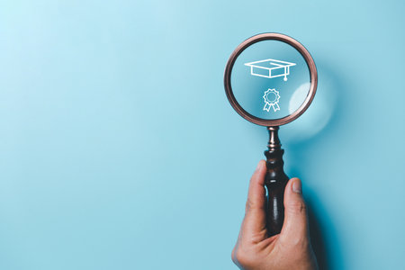 Hand holding a magnifying glass with education icons on a blue background. education concept. Creative idea and innovation.の写真素材