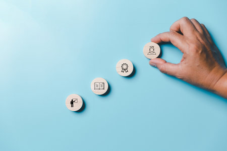 Success and necessary skills in graduation or education. Knowledge and teaching. Wooden cubes with graduation and education symbols linked. education concept. Creative idea and innovation.の写真素材