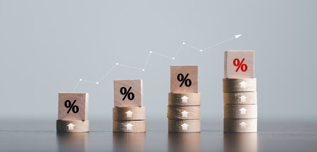 Closeup wood cubes with percentage symbol, Percent and upwards increasing arrows on wooden cubes. Financial interest mortgage rates increase or price commission raise, growth business, finance tax.の写真素材