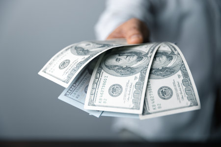 100 dollar cash bill is the biggest note bank. Financial investment success. Currency in America is dollar. Money exchange rate is up and down depend on USD. Wealthy people have a lots of money.の写真素材