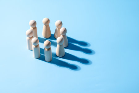 A wooden business teamwork symbol. Leadership styles concept of strategy cooperation. A group of employee from the company. The wooden symbol with light blue background. Professional business group.の写真素材