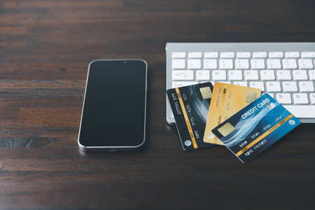 Modern Laptop on Business Work Desk with Credit Card - Technology and Finance Concept. Professional Business Workspace with Laptop, Keyboard, and Credit Card - Digital Economy.の写真素材