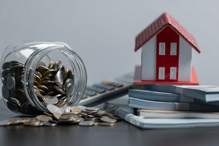 Loan application form paper with money coin and loan house model on table, Loan business finance economy commercial real estate investments. Home loan concept.の写真素材