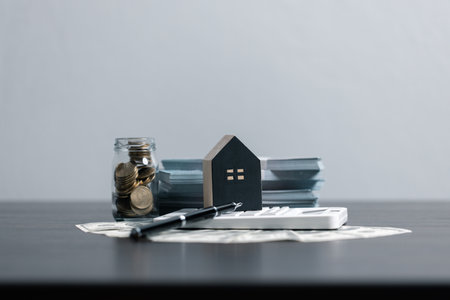 Loan application form paper with money coin and loan house model on table, Loan business finance...