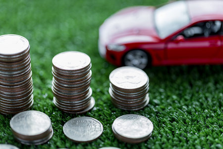 Car loan,money, banknote on agreement document or car insurance application form. Saving money for car concept, trade car for cash concept, finance concept.の写真素材