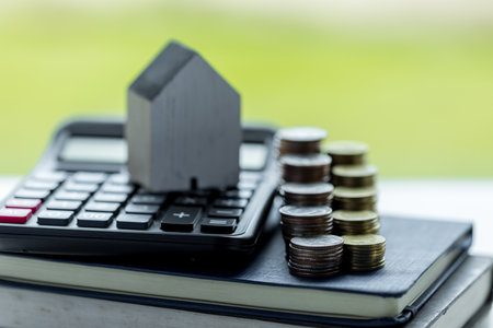 Business loans for real estate concept, money with model home on the table on bokeh background in the public park.の写真素材