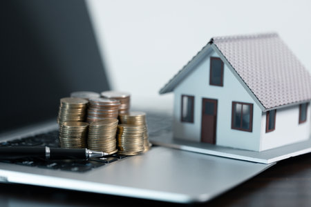 Business loans for real estate concept, money with model home on the table on office background.の写真素材