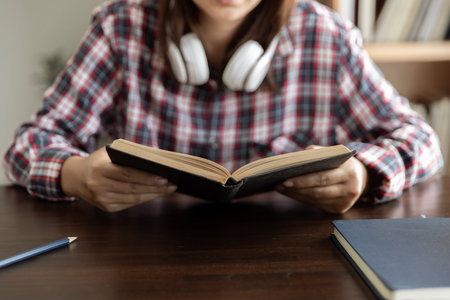 Asian woman student study online with teacher, happy young woman learn language listen lecture watch webinar look at laptop sit in home, distance educationの写真素材