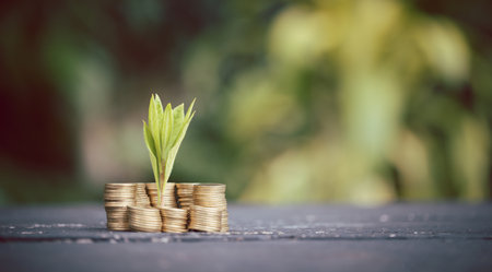 Coin pile and blurred green nature background money growth concept and business success concept....