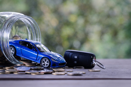 Car model on money coins pile. Finance and car loan, saving money for a car, coins insurance, loan and buying car finance concept. buy and installments down payment a car.の写真素材