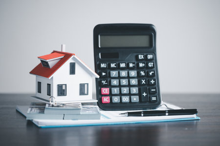 model home on wooden table, Save money concept, Property investment, house loan, reverse mortgage, gold coins money stack growth, saving money coins stack future for homeの写真素材