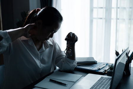 Hard think on analysis in the work. Young asian business woman is working on pressure in office. Tired business woman sleepy and bored from sitting at a desk for a long time and has office syndrome.の写真素材