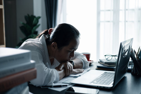 Hard think on analysis in the work. Young asian business woman is working on pressure in office....