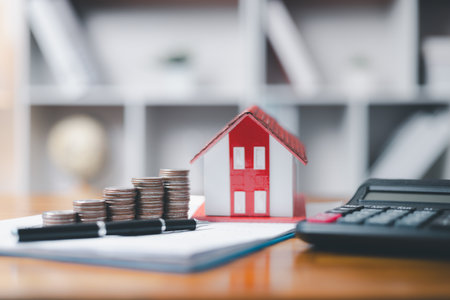 House model and money coins saving for concept saving money for buying a house, investment mortgage finance, and home loan refinance financial plan home. Property insurance and tax money.の写真素材