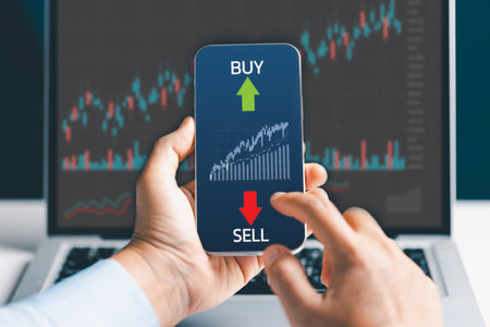 Businesswoman trader using smartphone with stock market investments and graph on screen to analyze trading data, buy or sell and checking price on mobile application.の写真素材