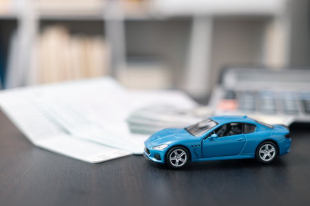 Business concept involved using finance calculator to determine premium for vehicle policy, ensuring clear financial contract for car. Investing in auto insurance can save money on transport costs.の写真素材