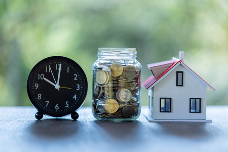 Investing money in property through mortgage loan, careful saving, turns each coin into valuable asset in real estate market, securing a house for future. finance, investment, loan, money.の写真素材