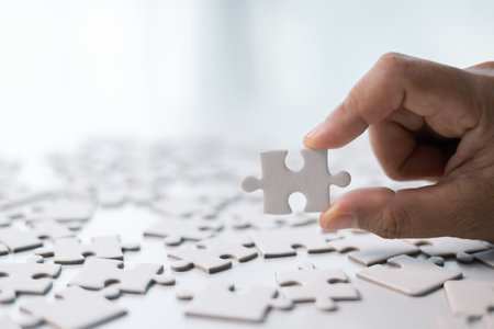 Team with piece of jigsaw puzzle as critical component of business strategy, understanding teamwork and collaboration were essential for achieving success and realizing concept of well-executed plan.の写真素材