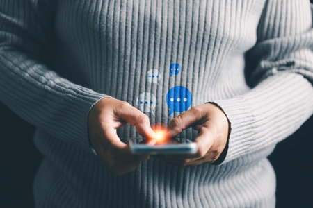 Person engages in marketing and business communication through social media, chatting on smartphone...
