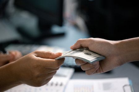 Person manage finances wisely, saving cash from their salary to ensure stable income for future payments and business investments. currency, money, saving, cash, hand, finance, financial, income.の写真素材