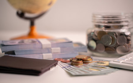 Effective finance management in business sector involves saving money, managing cash, and investing coins and currency to drive economic growth and strengthen banking and fund strategies.の写真素材