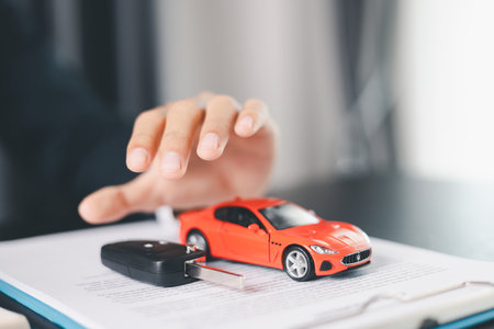 Concept business vehicle finance protection office plan investment buy sell car ensuring idea financial security. automobile agent hand protect purchase insurance and secure favorable loan deal.の写真素材