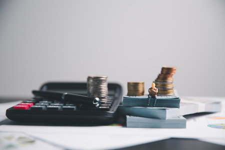 Financial calculate accountant blur background close up on calculator with graph chart banner bank office desk. Finance Concept tax banking money expense accounting budget businessman use calculator.の写真素材