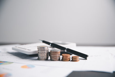 Financial calculate accountant blur background close up on calculator with graph chart banner bank office desk. Finance Concept tax banking money expense accounting budget businessman use calculator.の写真素材