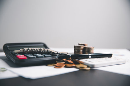 Financial calculate accountant blur background close up on calculator with graph chart banner bank office desk. Finance Concept tax banking money expense accounting budget businessman use calculator.の写真素材