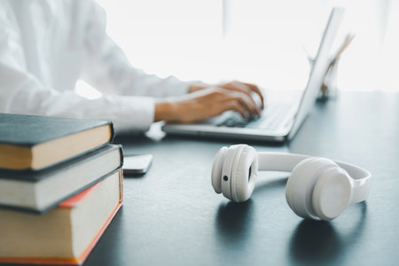 Education concept, learning and teaching with technology, e learning, teaching skills, digital online knowledge, cyberspace global, blur background banner white. hand playing laptop on desk indoor.の写真素材