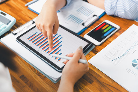 Teamwork with business people analysis cost graph on desk at meeting room. partnership analysis graph company financial budget report, cost work progress planning, business team analysis graph dataの写真素材
