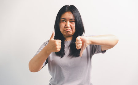 Asian girl expresses dislike, person express negative feeling, concept business complaint from customer ensuring employee satisfaction negative feedback to prevent mental strain customer dislikeの写真素材